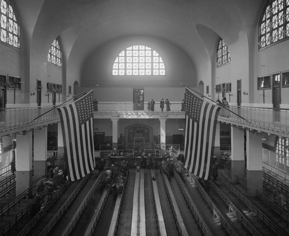 Ellis-Island-Virtual-Tour-The-Registry-Room-Adorned-by-US-flags Ellis-Island-Virtual-Tour-The-Registry-Room-Adorned-by-US-flags