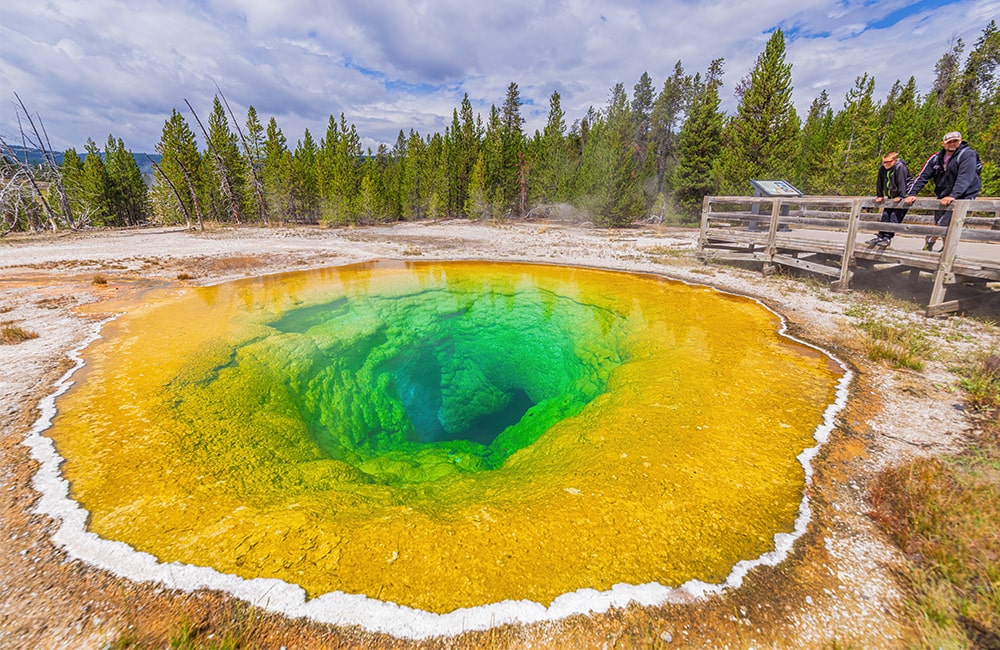 Father and son looking at the Morning Glory Pool at Yellowstone National Park